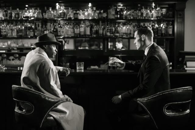 Two actors in a role at a bar